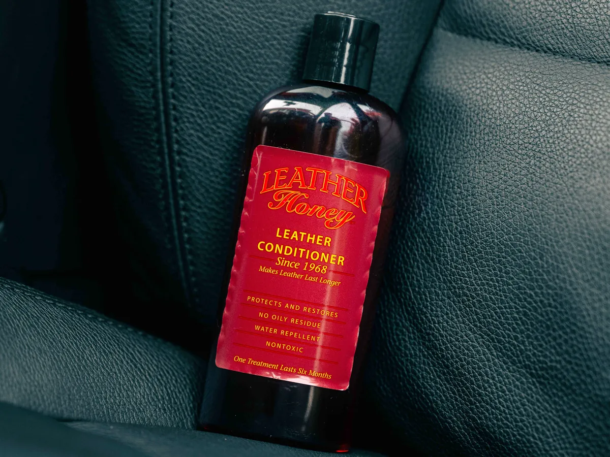 Bottle of Leather Honey Leather Conditioner on a black leather seat